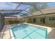 Inviting screened-in pool with a dolphin and adjacent hot tub with views of backyard at 2505 Buckhorn Run Dr, Valrico, FL 33596