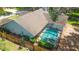 Aerial view of the home's screened-in pool and spa area surrounded by a wood fence at 2505 Buckhorn Run Dr, Valrico, FL 33596