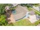 Aerial view of home's roof, screened-in pool, concrete driveway, and mature trees at 2505 Buckhorn Run Dr, Valrico, FL 33596