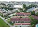 An aerial view of the condos, carports, a pond and surrounding greenery at 2593 Countryside Blvd # 7204, Clearwater, FL 33761