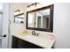 Bright bathroom featuring a vanity with countertop, framed mirror, and a shower/tub combo at 2593 Countryside Blvd # 7204, Clearwater, FL 33761
