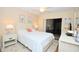 Comfortable bedroom featuring a queen-size bed, soft lighting, and access to the screened patio at 2593 Countryside Blvd # 7204, Clearwater, FL 33761