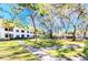 A sunny community green space with walking path and building at 2593 Countryside Blvd # 7204, Clearwater, FL 33761