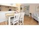 Dining area with seating for four, hardwood floors, and decorative accessories at 2593 Countryside Blvd # 7204, Clearwater, FL 33761