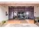 Building entrance featuring large glass doors and covered awning, tiled entry and potted plants at 2593 Countryside Blvd # 7204, Clearwater, FL 33761
