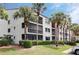 Exterior view of the condo building showing well-maintained landscaping and a serene atmosphere at 2593 Countryside Blvd # 7204, Clearwater, FL 33761
