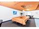 An indoor game room with a billiards table and high wood ceilings at 2593 Countryside Blvd # 7204, Clearwater, FL 33761