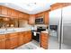 Kitchen with stainless steel appliances, ample counter space and wood cabinets at 2593 Countryside Blvd # 7204, Clearwater, FL 33761