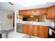 Kitchen with stainless steel dishwasher, ample counter space and wood cabinets at 2593 Countryside Blvd # 7204, Clearwater, FL 33761