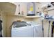 Functional laundry room with washer, dryer, and ample storage space, providing convenience for daily chores at 2593 Countryside Blvd # 7204, Clearwater, FL 33761