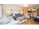 Open-concept living area with modern sofas, a cozy chair, and views into the dining space at 2593 Countryside Blvd # 7204, Clearwater, FL 33761