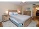 Relaxing main bedroom with a king-size bed, warm lighting, and stylish decor, providing a comfortable and inviting space at 2593 Countryside Blvd # 7204, Clearwater, FL 33761
