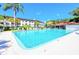 Large outdoor swimming pool with chairs and building at 2593 Countryside Blvd # 7204, Clearwater, FL 33761