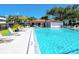 Large outdoor swimming pool with lounge chairs and a pergola at 2593 Countryside Blvd # 7204, Clearwater, FL 33761