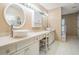 Bright bathroom with dual vessel sinks, vanity seating, and ample counter space for storage at 2704 Chambray Ln, Tampa, FL 33611