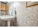 Half bath features a pedestal sink, decorative wallpaper and accent lighting at 2704 Chambray Ln, Tampa, FL 33611