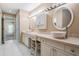 Bright bathroom with dual vessel sinks, vanity seating, and ample counter space adjacent to a bedroom at 2704 Chambray Ln, Tampa, FL 33611