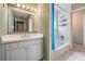 Bathroom featuring a white vanity, mirror, and lighting fixture, along with a combination tub and shower at 2704 Chambray Ln, Tampa, FL 33611