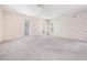 Spacious bedroom featuring three windows, plush carpet, and a ceiling fan providing plenty of natural light at 2704 Chambray Ln, Tampa, FL 33611