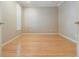 Bedroom features hardwood floors, neutral walls, and a shuttered window for natural light at 2704 Chambray Ln, Tampa, FL 33611