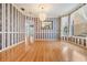 Elegant dining room features hardwood floors, striped wallpaper, chandelier and natural light at 2704 Chambray Ln, Tampa, FL 33611