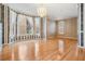 Dining room features hardwood floors, bay window, classic trim, chandelier and neutral walls at 2704 Chambray Ln, Tampa, FL 33611