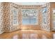 Sunlit dining area with bay windows, hardwood floors, and patterned wallpaper at 2704 Chambray Ln, Tampa, FL 33611