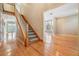 Bright foyer with hardwood floors, staircase, and an open floorplan to other living areas at 2704 Chambray Ln, Tampa, FL 33611