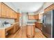 Bright kitchen with wood cabinets, stainless steel appliances, island with stove and ample counterspace at 2704 Chambray Ln, Tampa, FL 33611