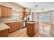 Bright kitchen with wood cabinets, granite countertops, stainless steel appliances, and an island at 2704 Chambray Ln, Tampa, FL 33611