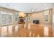 Spacious living room features a brick fireplace, French doors, hardwood floors and multiple windows at 2704 Chambray Ln, Tampa, FL 33611