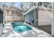 Backyard pool area featuring a refreshing in-ground pool with a screened enclosure and patio space at 2704 Chambray Ln, Tampa, FL 33611