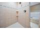 Tiled shower stall adjacent to the bathtub with built in shelves, creating a luxurious spa experience at 2704 Chambray Ln, Tampa, FL 33611