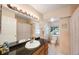 Bright bathroom features granite countertop, tiled walls, and a window for natural light at 2718 W Leila Ave, Tampa, FL 33611