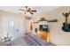 Comfortable bedroom features a ceiling fan, decorative guitars, and a closet at 2718 W Leila Ave, Tampa, FL 33611