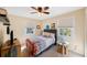 Cozy bedroom with natural light from two windows, a ceiling fan, and neutral decor at 2718 W Leila Ave, Tampa, FL 33611