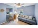 Comfortable blue bedroom featuring a seating area with a sofa, chair, and lots of natural light at 2718 W Leila Ave, Tampa, FL 33611