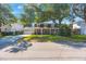 Traditional two-story home with a brick facade, an attached garage and mature trees at 2718 W Leila Ave, Tampa, FL 33611