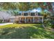 Beautiful brick home featuring a charming front porch, dormer windows, and a well-maintained lawn at 2718 W Leila Ave, Tampa, FL 33611
