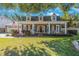 Charming brick home featuring a quaint front porch, dormer windows, and a well-manicured lawn at 2718 W Leila Ave, Tampa, FL 33611
