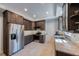 Well-lit kitchen with stainless steel appliances, granite countertops, and modern cabinetry at 2718 W Leila Ave, Tampa, FL 33611