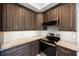 This kitchen features stainless steel appliances, granite counters and modern cabinetry at 2718 W Leila Ave, Tampa, FL 33611