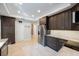 Updated kitchen features stainless steel appliances and ample dark wood cabinetry and neutral tile flooring at 2718 W Leila Ave, Tampa, FL 33611
