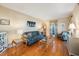 Elegant living room featuring hardwood floors, blue sofa, and stylish decor at 2718 W Leila Ave, Tampa, FL 33611