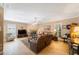 Cozy living room with fireplace, ceiling fan, and comfortable seating at 2718 W Leila Ave, Tampa, FL 33611