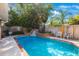 Backyard pool featuring a custom rock waterfall feature and lush landscaping at 2718 W Leila Ave, Tampa, FL 33611