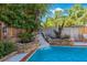 Backyard pool featuring a custom rock waterfall feature and lush landscaping at 2718 W Leila Ave, Tampa, FL 33611
