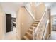Carpeted staircase with white banister leads to upper level at 2718 W Leila Ave, Tampa, FL 33611