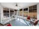 Bright sunroom with blue tile flooring, multiple windows, and comfortable seating at 2718 W Leila Ave, Tampa, FL 33611