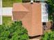Aerial view of a single-Gathering home featuring a large roof, driveway, landscaping, and backyard at 2720 Wiltshire Ave, Palm Harbor, FL 34685